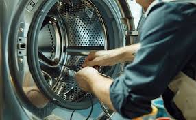 professional appliance technician repairing washing machine
